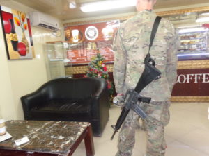 Soldier with an M16 in one of many coffee shops.