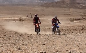 Bikes approaching the Dead Sea cliff from the Judean Desert.