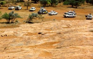 Bash cars at the base of rock.