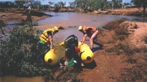 Mike and Damien drag their boat around a fallen tree.