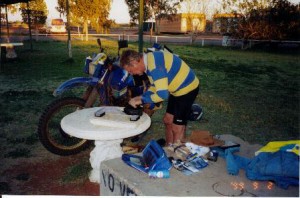 George servicing his bike at Kulgera.