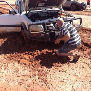 Graham removing mud to get MaxTrax under the wheel.