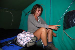 Tammy laughing at Kim's effort to remove a frog from the camper.
