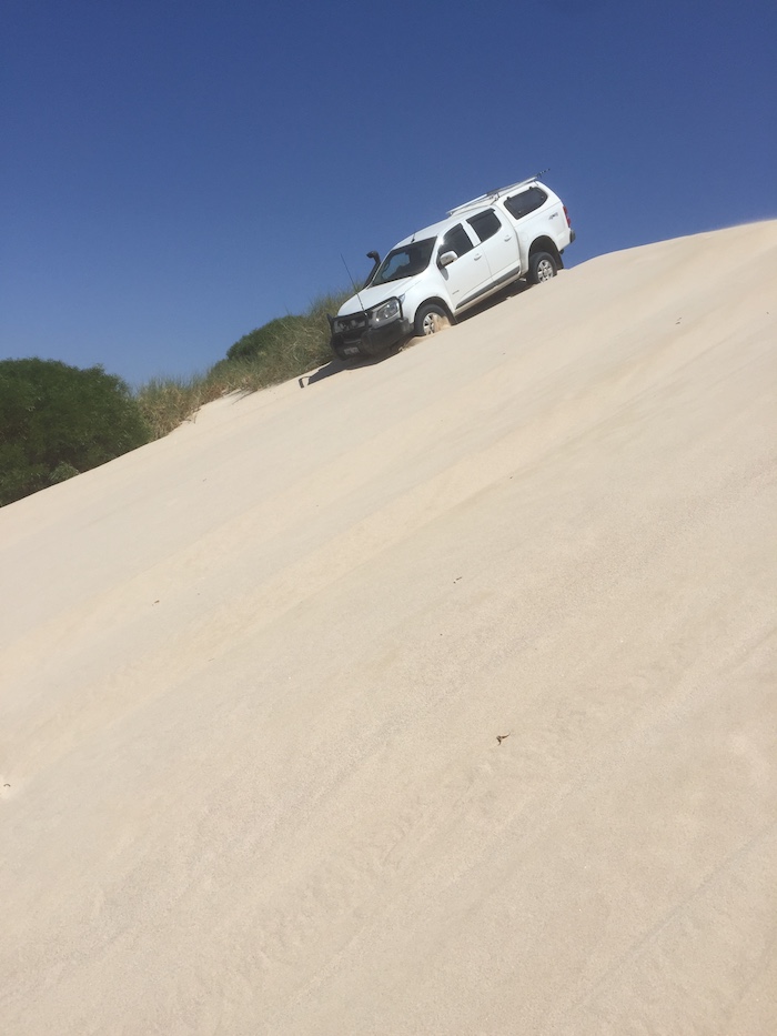 Greg descends the dune.