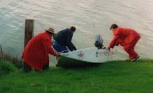 Kim, Kevin and Tony launch a boat.