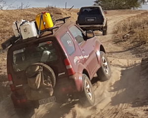Adi drives his Jimny out of the creek.