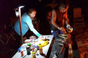 Penny and Joe dressing piglet.