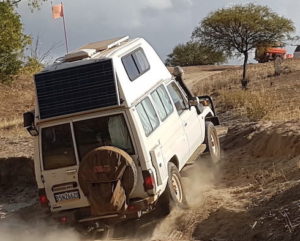 Steve drives his camper out of the creek.