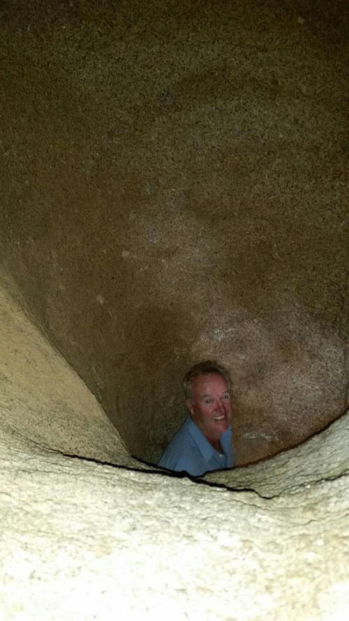 Scott at bottom of hollowed bell shape rock.