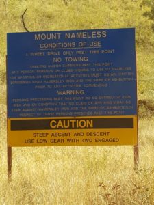 At the beginning of the drive up the hill.