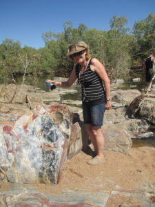 Helen pours water over the jasper to bring out the colours