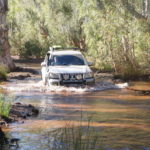 Jeff and Micaela through water at Skull Springs.