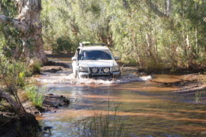 Jeff and Micaela through water at Skull Springs.