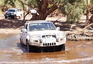 Kerry crosses the Oakover River in his Nissan Navara.