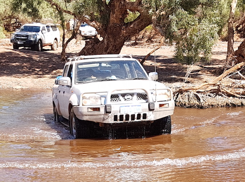 Kerry crosses the Oakover River in his Nissan Navara.