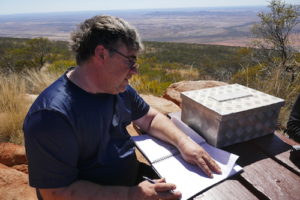 Mike records their achievement at the summit.