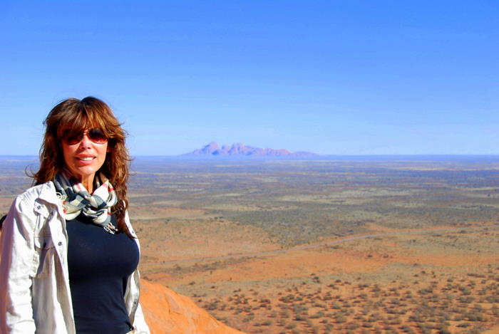 At the top of Uluru with Kata Tjuta in the background.