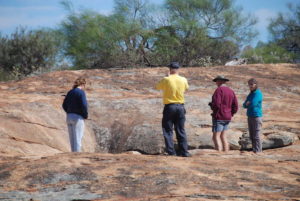 Inspecting a gnamma at Pigeon Rock.