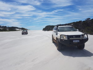 On the beach at the mouth of the Saint Mary River, Point Charles Bay, Fitzgerald River National Park. The sand bar on which the vehicles are parked is blocking the river from emptying into the ocean.