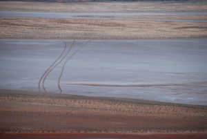 Motorcycle tracks across the salt lake.