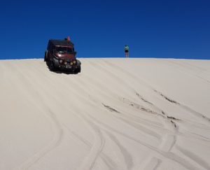 Nick takes his Jeep down the dune.