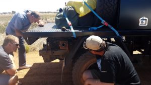 Andrew, Kerry and Matt watch as the fuel line is reverse flushed.