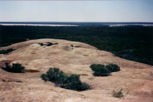 Look carefully and you will see a person in the centre of the photo. It is a big rock.