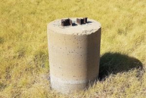 To maintain integrity of the telegraph line across the Roebuck Plains - subject to frequent flooding - the telegraph pole was held between two sections of railway mounted in concrete.