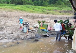 Locals offloading rice machine.