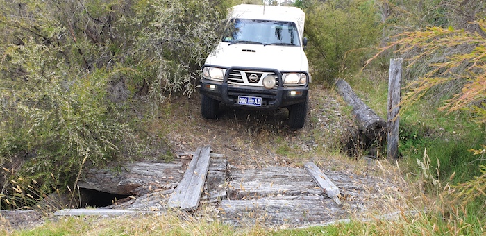 Mushy drives his Troopy over the wooden bridge.