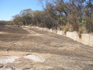 Harvest walls direct water to channels that lead to the dam.