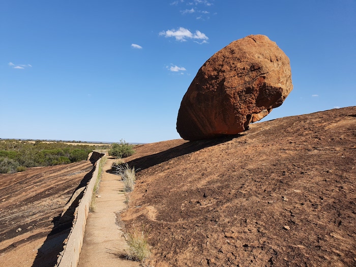 A balancing rock just above a harvest wall.