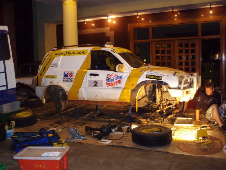 Major underbody repairs on the front steps of the hotel at Ooty.