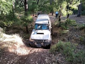 Scott takes his Patrol through a creek bed to get out of camp.