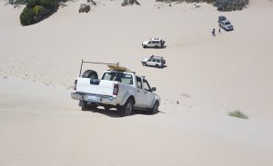 Kerry takes his Navara down the dune.