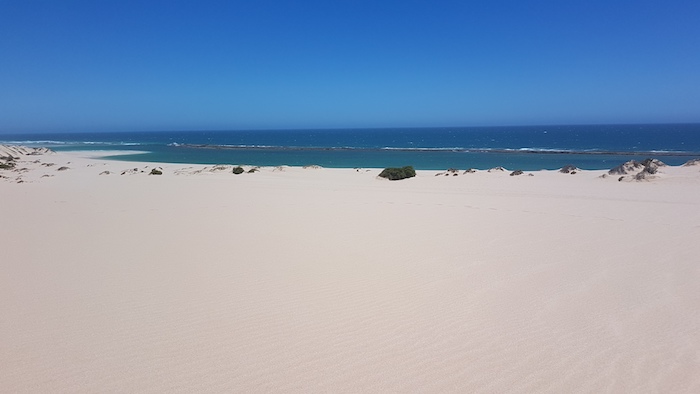 The length of the fringing reef can be seen from the top of the extensive dunes.