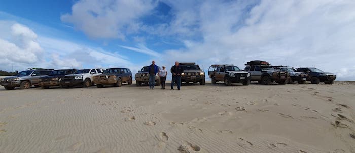 Vehicle lineup on top of first dune.