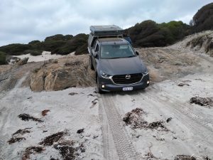 Greg and Margot in their new BT50 drop onto the beach.