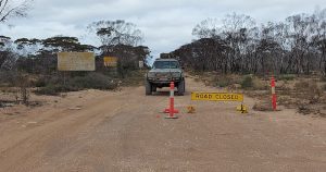 At the intersection of Balladonia Track and Eyre Highway. Note that the sign is positioned to allow access.