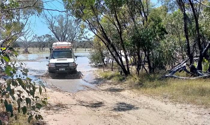 Keith negotiates the inundated track around the edge of the lake.